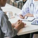 Person managing diabetes with healthy food and glucose check.